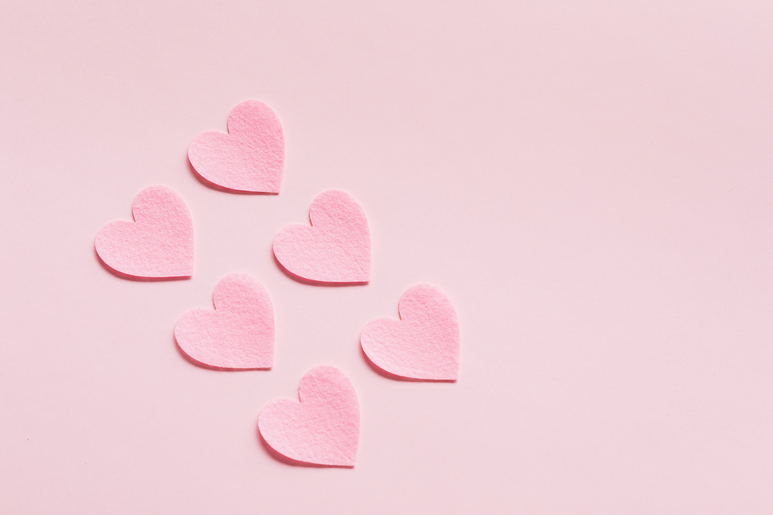 Heart shaped papers on pink background